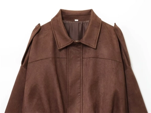 Close-up of brown suede jacket detailing classic shoulder epaulettes and collar