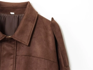 Detail of dark brown suede jacket collar with visible stitching and metal zipper