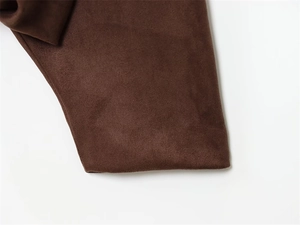Detailed close-up showing the soft suede texture and premium stitching of the brown jacket