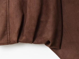 Macro detail of dark brown faux suede jacket fabric with precise single-needle stitching