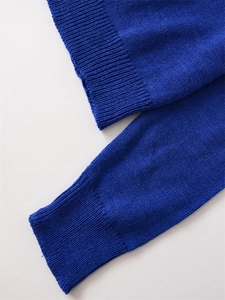 Detailed close-up of ribbed knit cuffs and hem on vibrant royal blue cashmere blend sweater