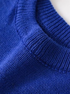 Detailed macro view of the royal blue knitted texture and ribbed crew neck finish