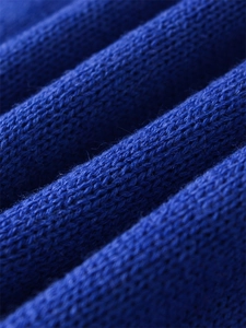 Detailed macro view of dark blue cashmere wool blend knit fabric texture and softness