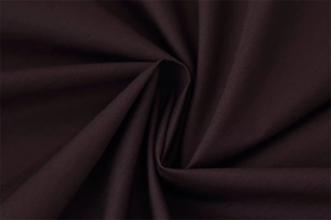 Detailed close-up of dark brown poplin fabric showing fine texture and soft drape