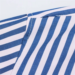 Macro detail of high-quality blue and white striped poplin fabric with neat stitching