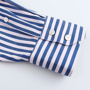 Detail of blue and pink striped poplin shirt cuff with white buttons and neat stitching