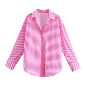 Close-up of pink and white vertical stripes on long sleeve poplin shirt with buttoned cuffs