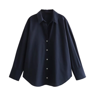 Detail view of navy blue striped cotton shirt featuring white buttons and a classic collar