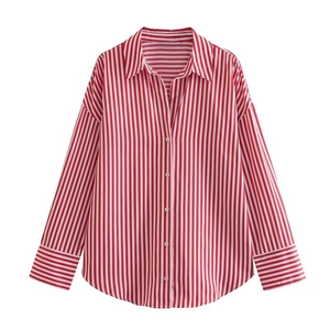 Detailed view of red and white vertical striped poplin shirt with white button closure