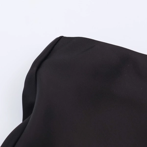 Close-up of black silk satin fabric texture and premium folded seam stitching detail