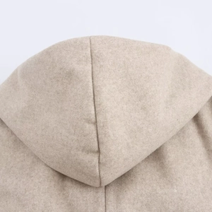 Detail of the hooded wool coat stitching on the back in a soft oatmeal texture