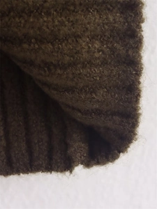 Macro shot of deep olive green ribbed knit fabric showing thick texture and soft fibers
