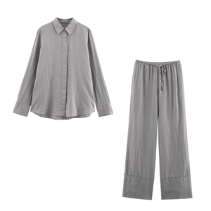 Detailed view of gray linen shirt and wide-leg pants set with a drawstring waistband