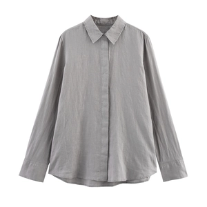 Detailed flat lay of a grey linen shirt showing lapel collar and button cuffs