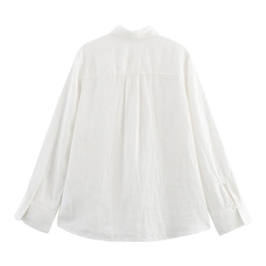 Detail view of the back pleat on this white linen shirt with a natural texture