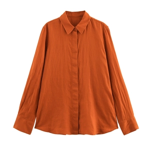 Flat lay of terracotta long-sleeve linen shirt with buttoned cuffs and hidden placket