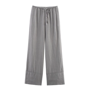 Detailed view of grey linen wide-leg trousers with adjustable drawstring elastic waist