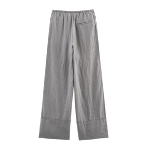 Detail of grey linen wide-leg pants with elastic waist and stitched hemline details