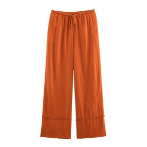 Detail of wide-leg linen pants showing elastic waistband with drawstring and fabric texture