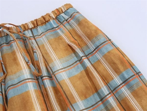 Detail of checkered ramie lantern pants with elastic waist and drawstring cord