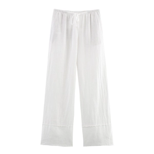 Close-up of white linen wide-leg pants showing elastic waistband with drawstring