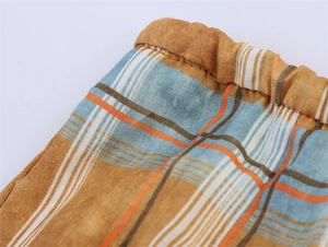 Detailed macro view of checkered ramie fabric with double stitching and pleated texture