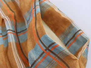 Detailed close-up of ramie plaid fabric showing intricate weave and pocket stitching