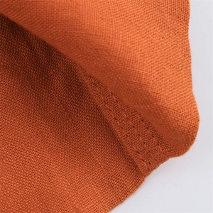 Detailed macro view of caramel linen fabric with plain weave and fine hemmed stitching