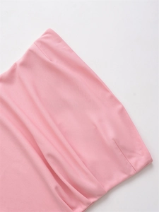 Detailed macro view of pink fabric texture and precise stitching on the ruched top