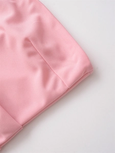 Detailed close-up showing the precise stitching and fine texture of the pink pleated fabric