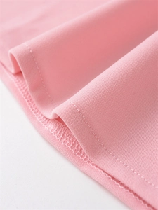 Detail shot of pink pleated top showing professional double-stitch sewing and fabric texture