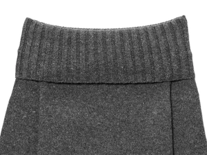 Close-up of charcoal grey knit sweater showing ribbed texture and fine stitching detail