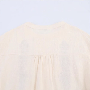 Beige round neck cotton linen shirt for women featuring elegant pleated back detail