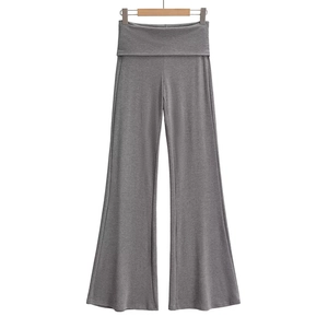 Detail of grey high-waisted wide-leg trousers featuring a unique fold-over waistband design