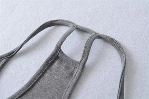 Close-up of the ribbed knit fabric and reinforced strap stitching on gray camisole