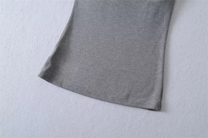 Detailed macro view of the grey knit fabric hem with professional double-needle stitching