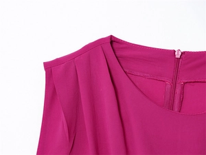 Detail of rose red sleeveless dress featuring shoulder pleats and back zipper closure