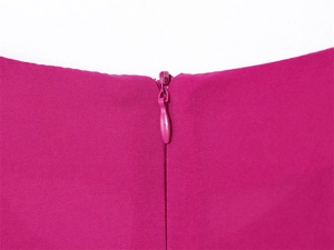 Detailed macro view of the seamless invisible zipper on a rose red sleeveless dress