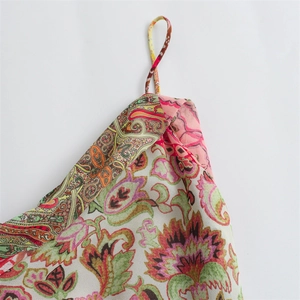 Detail of bohemian floral paisley print dress with delicate thin spaghetti straps