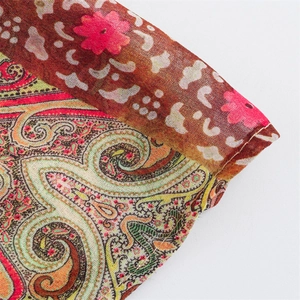 Detailed macro view of the intricate paisley print and double stitching on the fabric sleeve