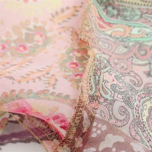 Close-up detail of paisley printed fabric showing high-quality overlock stitching
