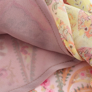 Detailed close-up of floral patchwork stitching and lining on a slim fit chiffon dress