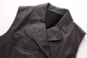 Detail of vintage brown faux leather vest showing retro collar and contrast stitching