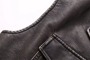 Macro detail of high-quality black faux leather material and fine stitching on the vest