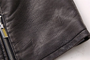 Close-up of premium textured faux leather fabric and silver metal zipper detail