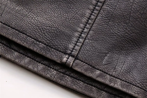 Macro shot of high-quality pebbled faux leather texture with durable double stitching detail