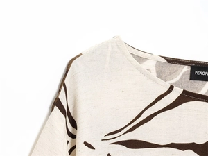Detail of cream floral top collar showing cotton linen texture and PEAOFL brand label