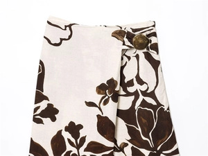 Detail of floral linen skirt featuring high waist with vintage brass buckle accent