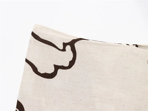 Detailed macro view of beige linen fabric with abstract dark brown cloud patterns