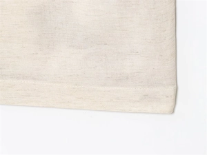Close-up of oatmeal heathered knit fabric showing fine stitching and soft texture